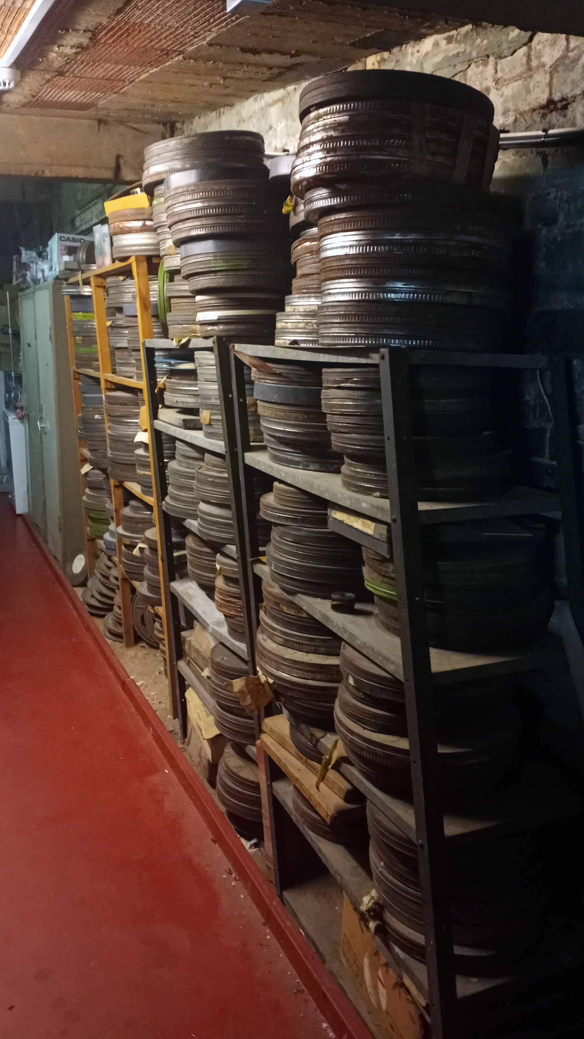Shelves of 35mm film cans in a cinema basement